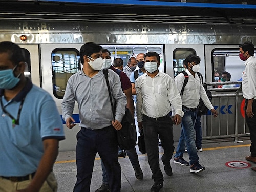 People commute in a metro at a station after the services were allowed to operate at 50 percent capacity in New Delhi on June 7, 2021, as India's capital began a gradual easing of restrictions after Covid-19 coronavirus infections across the country fell to a two-month low. (Photo by Money SHARMA / AFP)