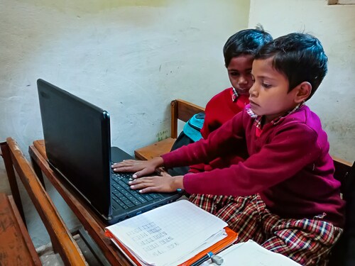District Katni, Madhya Pradesh, India - January 13, 2020: Indian village school male kids learning about laptop technology at classroom.