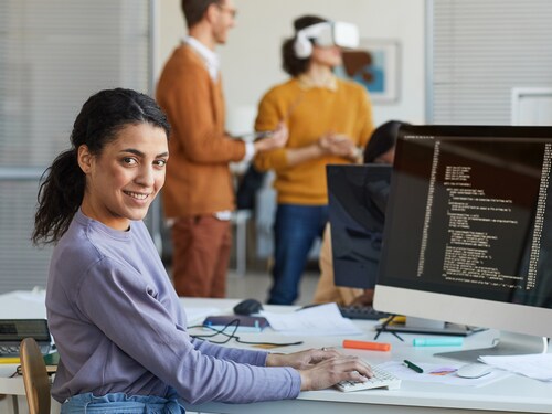 Ethnic Young Woman Programming Software in Office