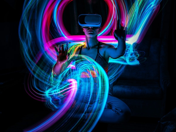Metaverse digital Avatar, Metaverse Presence, digital technology, cyber world, virtual reality, futuristic lifestyle. Woman in VR glasses playing AR augmented reality NFT game with neon blur lines