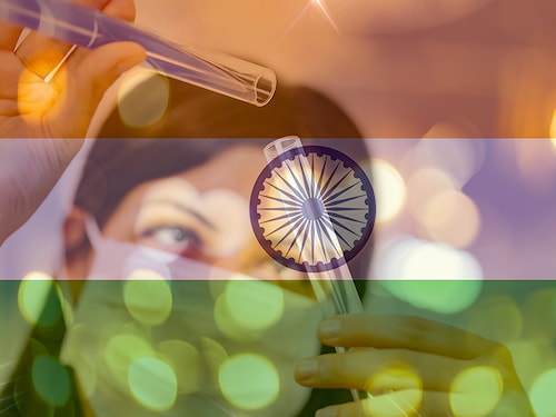INDIA and cancer vaccine, young chemical female researcher holding syringe and ampoule with fluid in laboratory. india flag with female doctor Health expenditure