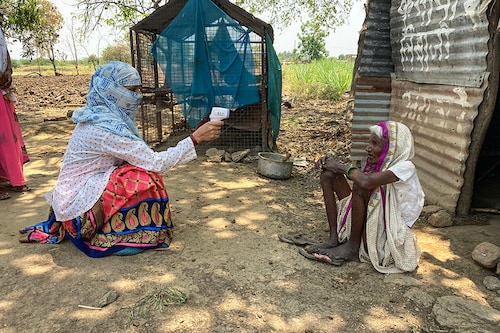 ASHA health worker checking temperature of a tribal woman in rural area of Maharashtra, India. Image: Shutterstock