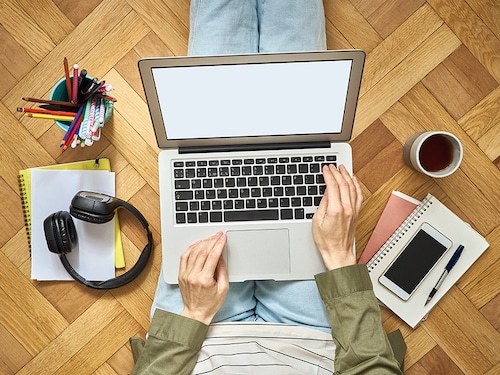 Mock up, template for online shopping, online learning, work at home. Home office. Empty blank laptop screen, woman typing on keyboard, top view