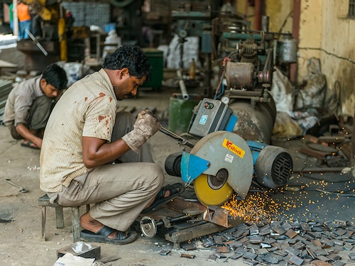 Raebareli, Uttar Pradesh/India- June 17 2019 : Man working with Metal/Steel Cutting Machine ,  MSME industry at Raebareli industrial area,