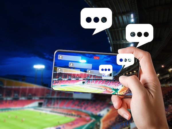 Hands use smartphones record soccer competition match in football stadium live streaming video on internet to social media comment chat to Friend