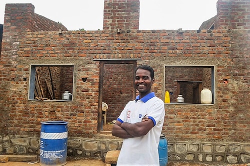 Santosh More at a construction site in Raigad where he assists as a mason. Image: Swades Foundation