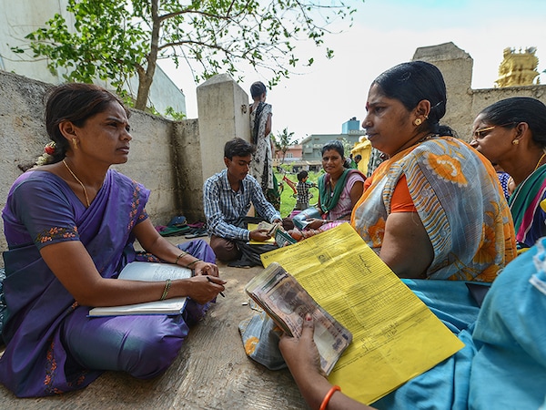 BANGALORE, INDIA - JUNE 3: Member of a Microfinance Institution (MFI) at a monthly meeting held at one of the customers house, which is one of the meeting point to collect the monthly Equated Monthly Installment (EMI) on June 3, 2015 in Bangalore, India. (Photo by Hemant Mishra/Mint via Getty Images)