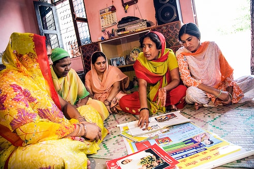 ASHA volunteers giving health tips to village women, Mewat, Haryana, India. Image: Hemant Mehta/ Getty Images