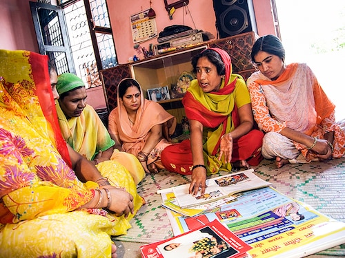 ASHA volunteers giving health tips to village women, Mewat, Haryana, India. (Photo by: Hemant Mehta/IndiaPictures/Universal Images Group via Getty Images)