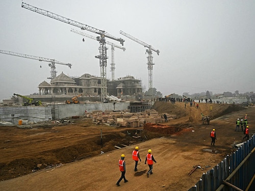 Workers are pictured at the construction site of a temple to Hindu deity Ram, in Ayodhya on December 29, 2023. (Photo by Arun SANKAR / AFP)