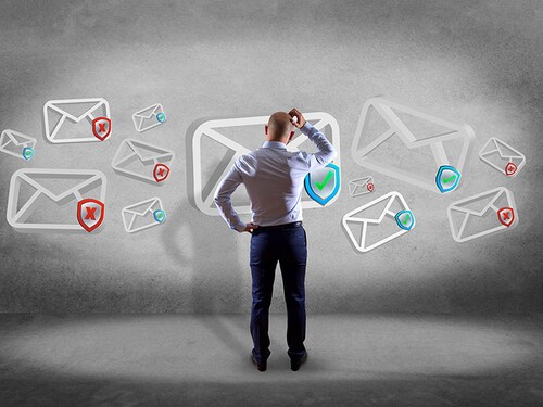View of a Businessman in front of a wall with Approved email and spam message displayed on a futuristic interface - Message and internet concept