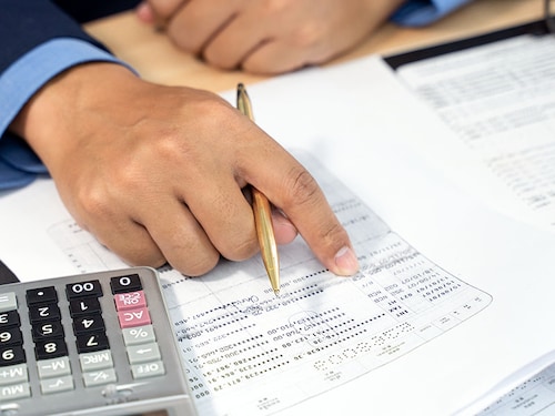 Accountant calculate tax information or business data. Businessman working in office