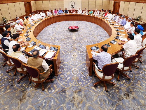 This handout photograph taken and released on June 10, 2024 by the Indian Press Information Bureau (PIB) shows India's Prime Minister Narendra Modi (C) holding the first cabinet meeting, in New Delhi. - Indian Prime Minister Narendra Modi unveiled on June 10 his coalition government after a surprise election setback lost his Hindu-nationalist party an overall majority. The 71 members of his government took the oath of office after Modi on June 9, with 11 posts going to coalition allies who extracted them in exchange for their support -- including five in the top 30 cabinet posts. (Photo by PIB / AFP) / RESTRICTED TO EDITORIAL USE - MANDATORY CREDIT "AFP PHOTO / INDIAN PRESS INFORMATION BUREAU (PIB) " - NO MARKETING NO ADVERTISING CAMPAIGNS - DISTRIBUTED AS A SERVICE TO CLIENTS