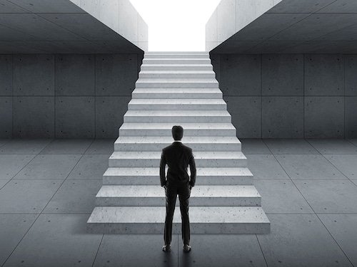 Businessman looking at stairs. business start concept