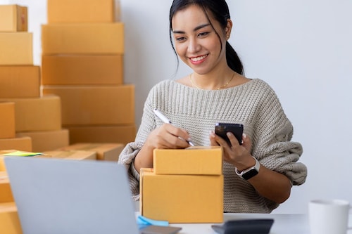 Startup small business entrepreneur SME, asian woman receive order on phone. Success young Asian small business owner home office, online sell marketing delivery, SME e-commerce telemarketing concept