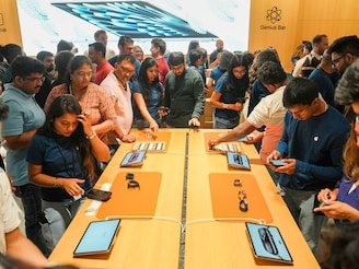 Customers look at Apple's products on display during the launch of the company's new store at Hebbal in Bengaluru, Karnataka. This is Apple's first retail store in south India, and third outlet in the country. Image: Shailendra Bhojak/PTI