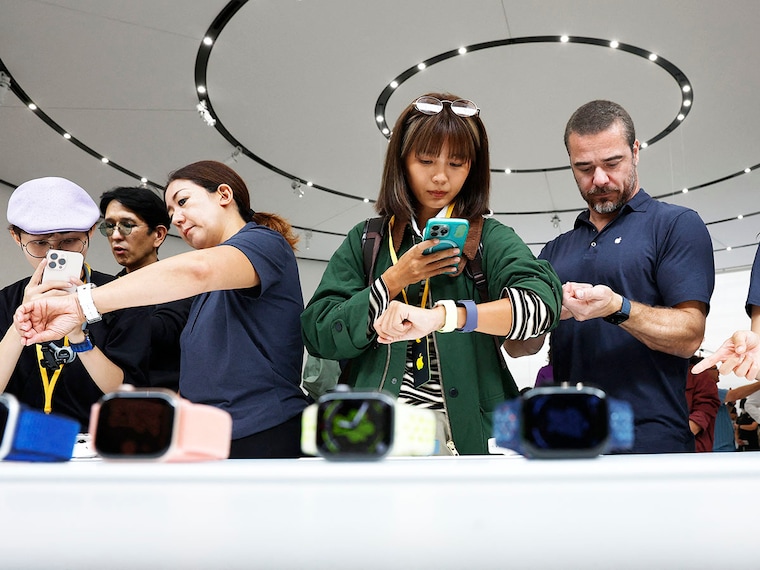 Attendees inspect new Apple watches during a special event at the Apple headquarters on September 9, 2025, in Cupertino, California. Apple unveiled a new generation of iPhones, updated Apple Watches, and AirPods during a special event.