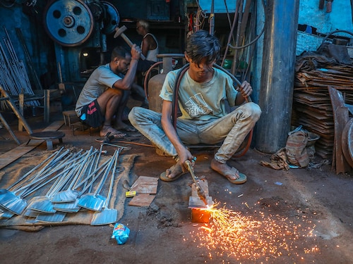 (File) A worker is welding an iron plate to make utensils at an iron utensils manufacturing unit in Kolkata, India.
(Photo by Rupak De Chowdhuri/NurPhoto via Getty Images) (File) A worker is welding an iron plate to make utensils at an iron utensils manufacturing unit in Kolkata, India.
(Photo by Rupak De Chowdhuri/NurPhoto via Getty Images)