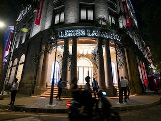 Pedestrians walk past the Galeries Lafayette store in Mumbai on October 15, 2025. The French luxury retailer marked its entry into India with the launch of its first store, aiming to tap into the country’s fast-growing luxury market.
Image: Punit Paranjpe / AFP