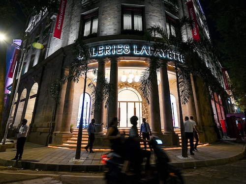 Pedestrians walk past the Galeries Lafayette store in Mumbai on October 15, 2025. The French luxury retailer marked its entry into India with the launch of its first store, aiming to tap into the country’s fast-growing luxury market.