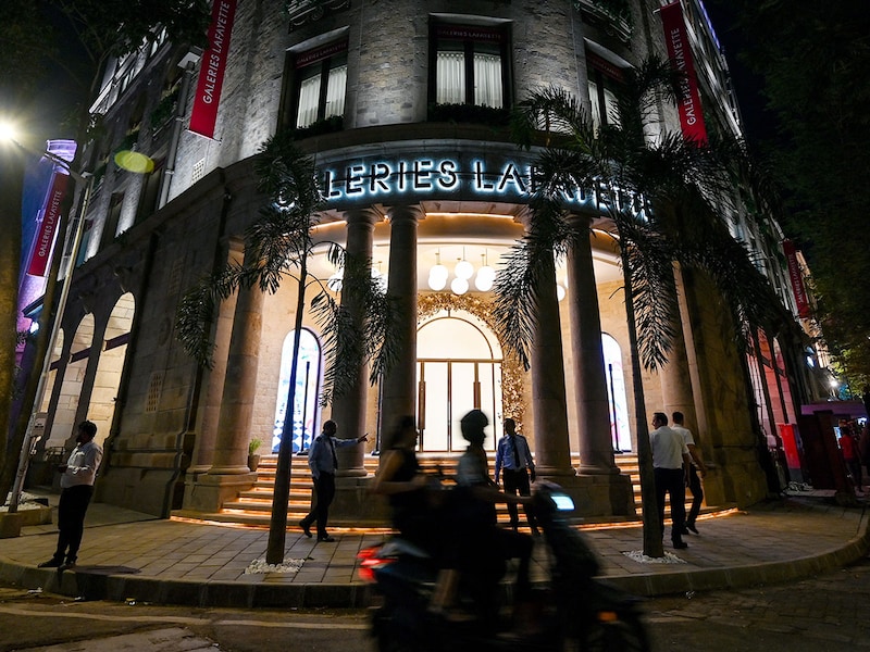 Pedestrians walk past the Galeries Lafayette store in Mumbai on October 15, 2025. The French luxury retailer marked its entry into India with the launch of its first store, aiming to tap into the country’s fast-growing luxury market.