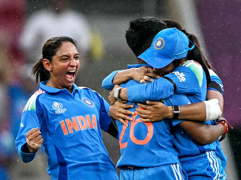 India's captain Harmanpreet Kaur (L) celebrates with teammates after the dismissal of Australia's captain Alyssa Healy during the ICC Women's Cricket World Cup 2025 one-day international (ODI) semi-final match between India and Australia at the DY Patil Stadium in Navi Mumbai on October 30, 2025.