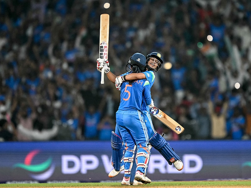 India's Jemimah Rodrigues (front) and Amanjot Kaur celebrate their team's win at the end of the ICC Women's Cricket World Cup 2025 one-day international (ODI) semi-final match between India and Australia at the DY Patil Stadium in Navi Mumbai on October 30, 2025. Photo by Punit PARANJPE / AFP