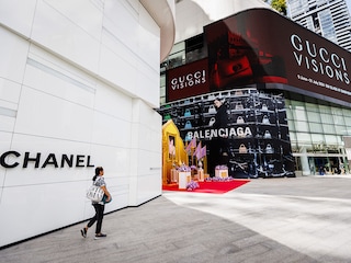 A woman walks past the entrance to the Chanel store at EmQuartier shopping mall in Bangkok, Thailand. 
Image: Lauren DeCicca/Getty Images