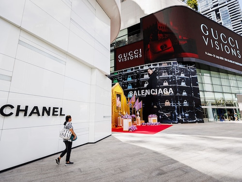 A woman walks past the entrance to the Chanel store at EmQuartier shopping mall in Bangkok, Thailand. 
Image: Lauren DeCicca/Getty Images