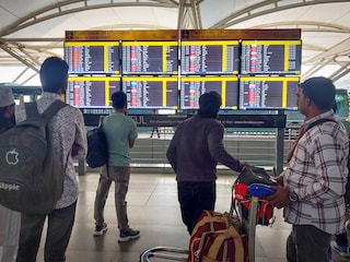 People wait outside the departure terminal at New Delhi's Indira Gandhi International Airport after schedule of around 800 flights got disrupted due to ATC technical glitch, November 7, 2025. 

Credit:  Sanjeev Verma/HT via Getty Images