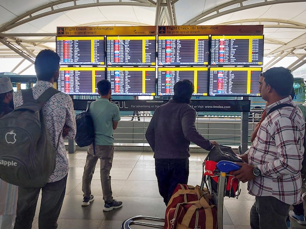 People wait outside the departure terminal at New Delhi's Indira Gandhi International Airport after schedule of around 800 flights got disrupted due to ATC technical glitch, November 7, 2025. 

Credit:  Sanjeev Verma/HT via Getty Images