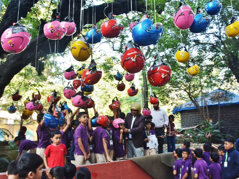 Helmet Man of India Raghavendra Kumar and his team organized helmet distribution to school students to create to create awareness about road safety and helmets among people from a young age at Thane collector office premises on November 20, 2025 in Thane, India. The initiative urged the assembled 100 students not only to wear helmets while cycling or riding pillion but also to encourage their parents and elders to use helmets while riding two-wheelers. Photo by Praful Gangurde/Hindustan Times via Getty Images