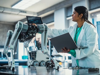 Young Indian Engineer Testing Industrial Programmable Robot Animal in a Factory Development Workshop. Photo by Gorodenkoff/Shutterstock 