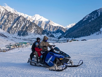 A motor sledge operator takes tourists on a ride over a snow-covered slope at Sonamarg on January 7,2026. Kashmir has witnessed a steady decline in winter precipitation, recording significant snowfall deficits. Rising temperatures and shifting weather patterns are accelerating glacier melt and putting pressure on the Valley's fragile ecosystem. Photo by Idrees Abbas/SOPA Images/LightRocket via Getty Images
