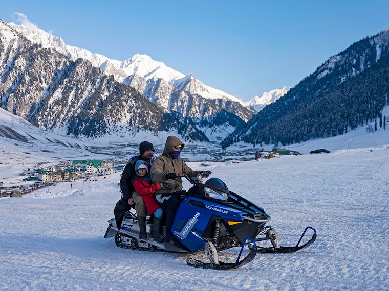 A motor sledge operator takes tourists on a ride over a snow-covered slope at Sonamarg on January 7,2026. Kashmir has witnessed a steady decline in winter precipitation, recording significant snowfall deficits. Rising temperatures and shifting weather patterns are accelerating glacier melt and putting pressure on the Valley's fragile ecosystem. Photo by Idrees Abbas/SOPA Images/LightRocket via Getty Images