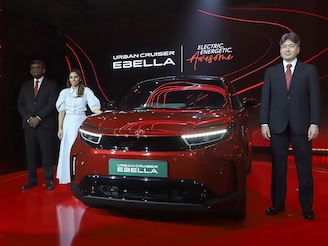 (from left) Toyota Kirloskar Motor's Sabari Manohar, Manasi Kirloskar and Tadashi Asazuma pose with the Toyota Urban Cruiser Ebella electric vehicle during a launch event in Mumbai on January 20, 2026.