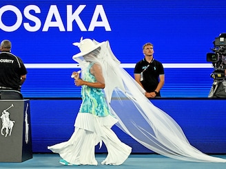Naomi Osaka: The four-time Grand Slam champion made a jaw-dropping entrance to the Rod Laver Arena for her first round match with a jellyfish-inspired outfit that came with a veil, a wide-brimmed hat and a parasol over an ocean blue tie-dye tracksuit. She pared down her outfit for the second-round match, where an awkward and angry handshake made the headlines. Photo by REUTERS/Jaimi Joy Naomi Osaka: The four-time Grand Slam champion made a jaw-dropping entrance to the Rod Laver Arena for her first round match with a jellyfish-inspired outfit that came with a veil, a wide-brimmed hat and a parasol over an ocean blue tie-dye tracksuit. She pared down her outfit for the second-round match, where an awkward and angry handshake made the headlines. Photo by REUTERS/Jaimi Joy