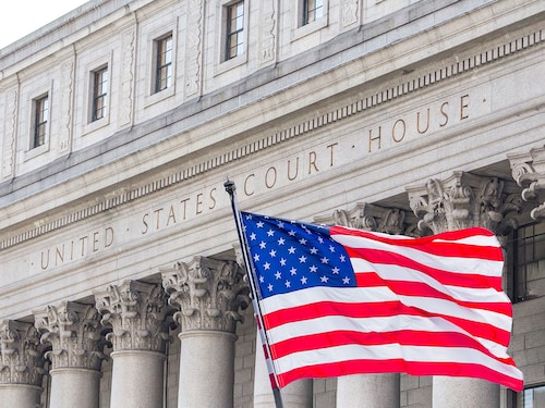USA national flag waving in the wind in front of United States Court House in New York