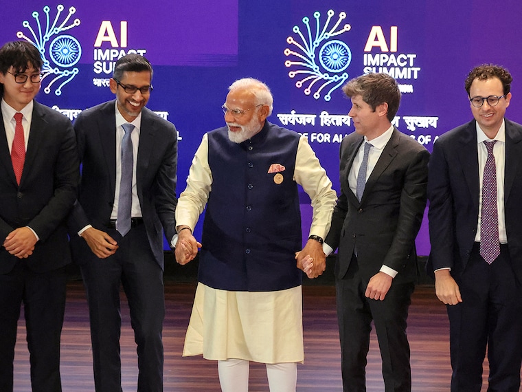 India's Prime Minister Narendra Modi takes a group photo with AI company leaders including OpenAI CEO Sam Altman (2nd R), Anthropic CEO Dario Amodei (R), Google CEO Sundar Pichai (2nd L), and Meta Chief AI Officer Alexandr Wang (L), at the AI Impact Summit in New Delhi on February 19, 2026.