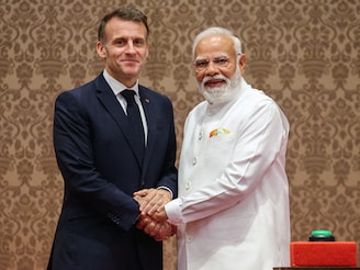 France's President Emmanuel Macron (L) and India's Prime Minister Narendra Modi shake hands at a press event to deliver joint declarations in Mumbai on February 17, 2026.  Photo by Ludovic Marin / AFP 