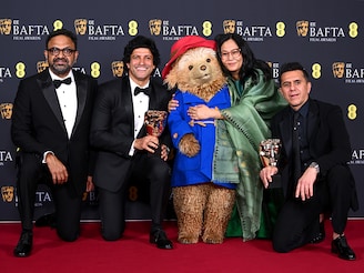 Lakshimipriya Devi and Ritesh Sidhwani accept the Children's & Family Film Award for 'Boong' with Alan McAlex, Farhan Akhtar and Paddington Bear during the 2026 EE BAFTA Film Awards, held at the Royal Festival Hall on February 22, 2026 in London, England. Photo by Joe Maher/BAFTA/Getty Images for BAFTA