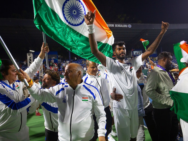 Dhakshineswar Suresh of Team India celebrates with team mates after beating Guy Den Ouden of Team Netherlands to win the Davis Cup Qualifier first round match between India and Netherlands at the S. M. Krishna Tennis Stadium on February 08, 2026 in Bengaluru, India. Suresh pulled off a performance for the ages, playing a part in all three of the Indian tennis team’s wins as India clinched a thrilling 3-2 win in their Davis Cup clash against the Netherlands.