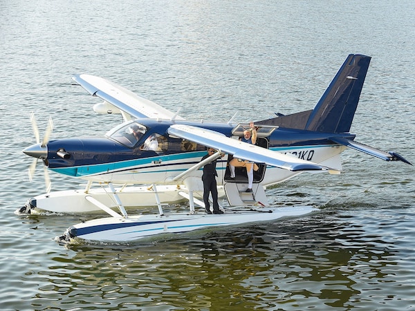 (File) Indian Prime Minister Narendra Modi (C) waves as he stands on a seaplane after landing at the Sabarmati river in Ahmedabad.
(Photo by SAM PANTHAKY / AFP)