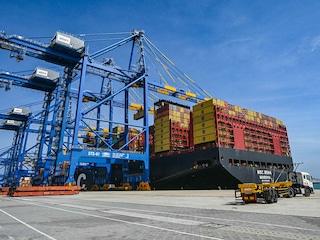 (File) Cargos are unloaded from a ship docked at the Vizhinjam International Seaport in Thiruvananthapuram. Photo by Indranil Mukherjee / AFP