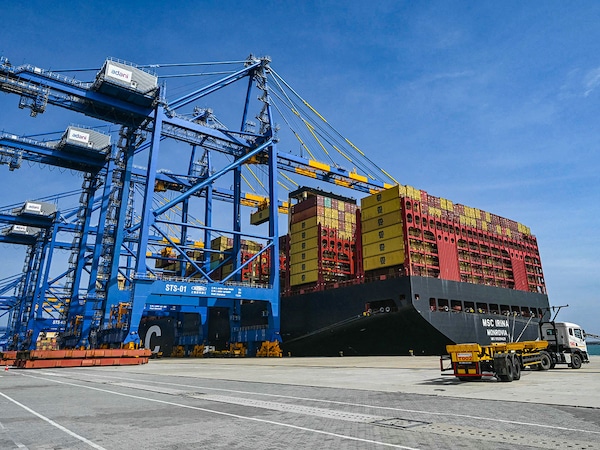 (File) Cargos are unloaded from a ship docked at the Vizhinjam International Seaport in Thiruvananthapuram. Photo by Indranil Mukherjee / AFP