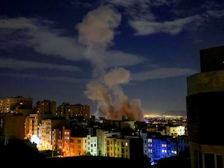 A smoke plume rises following a missile strike on a building in Tehran on March 1, 2026. The United States and Israel launched strikes against Iran on February 28, killing Iran's supreme leader and top military leaders, prompting authorities to retaliate with strikes on Israel and US bases across the Gulf. (Photo by ATTA KENARE / AFP)