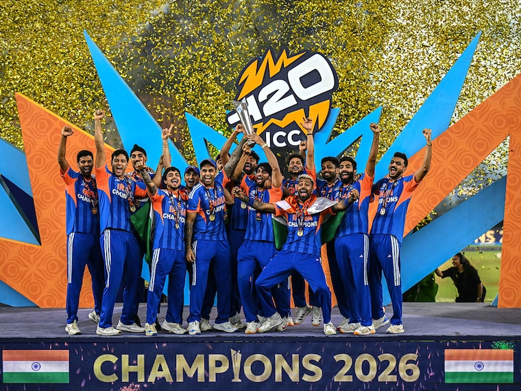 India's players celebrate with the trophy after winning the 2026 ICC Men's T20 Cricket World Cup final match against New Zealand at the Narendra Modi Stadium in Ahmedabad on March 8, 2026.