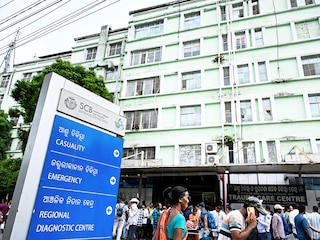 : Relatives of fire victims gather outside the trauma care centre at SCB Medical College and Hospital in Cuttack on March 16, 2026. A fire at a government-run hospital in eastern India killed at least 10 critically ill patients who were admitted in the trauma care centre, officials said on March 16.  Photo by AFP