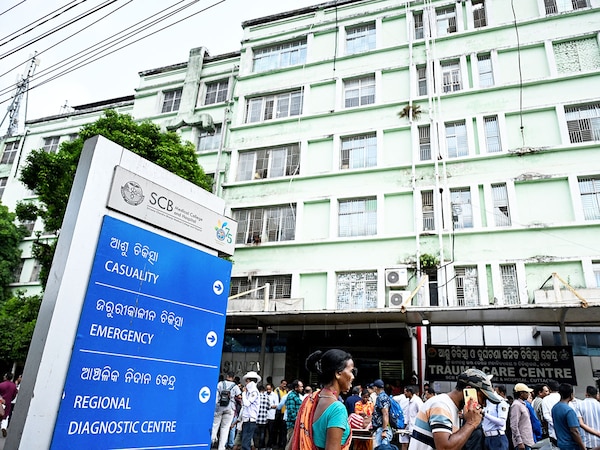 : Relatives of fire victims gather outside the trauma care centre at SCB Medical College and Hospital in Cuttack on March 16, 2026. A fire at a government-run hospital in eastern India killed at least 10 critically ill patients who were admitted in the trauma care centre, officials said on March 16.  Photo by AFP