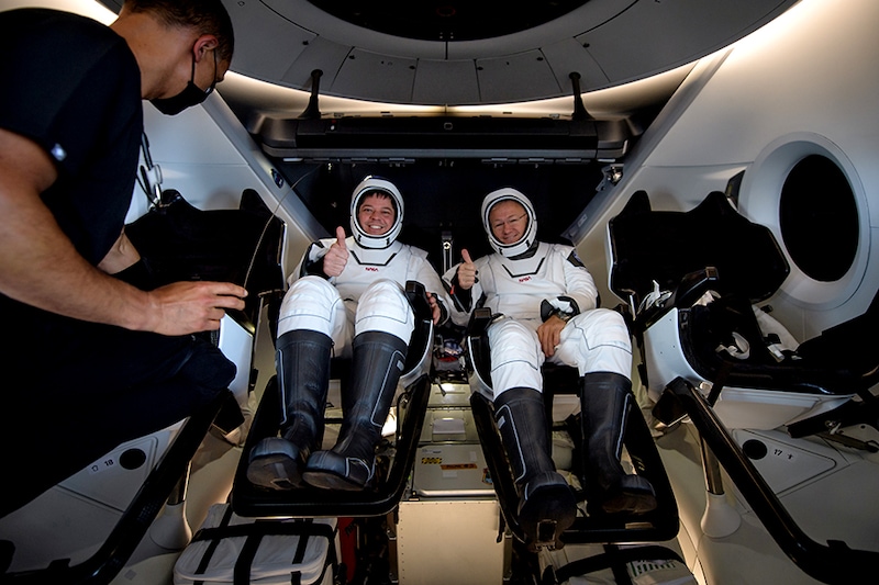 NASA astronauts Robert Behnken, left, and Douglas Hurley are seen inside the SpaceX Crew Dragon Endeavour spacecraft onboard the SpaceX GO Navigator recovery ship shortly after having landed in the Gulf of Mexico off the coast of Pensacola, Florida, US, August 2, 2020.